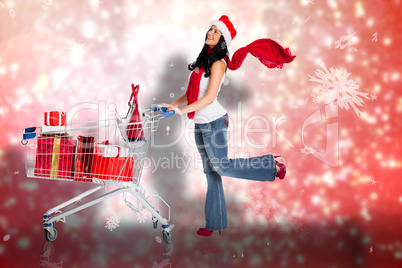 Composite image of woman standing with shopping trolley