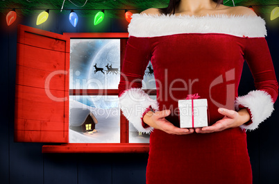 Composite image of pretty girl in santa outfit holding gift