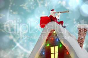 Composite image of santa sitting on roof of cottage