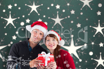 Composite image of couple holding a christmas gift