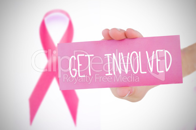 Composite image of young woman holding pink  card