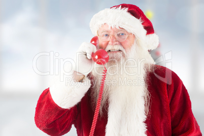 Composite image of santa claus on the phone