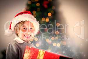 Composite image of child opening his christmas present