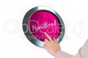 Hand pressing pink button for breast cancer awareness