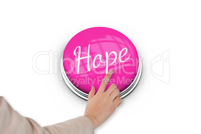 Hand pressing pink button for breast cancer awareness