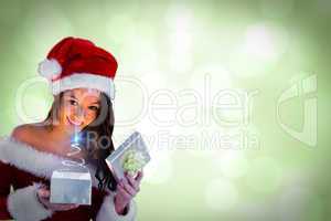 Composite image of sexy santa girl opening gift