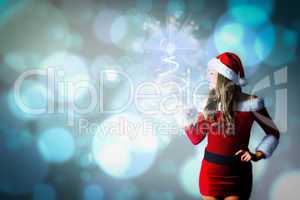 Composite image of pretty girl in santa costume holding hand out