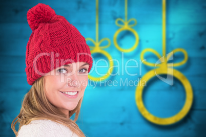 Composite image of happy blonde in winter clothes