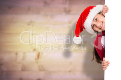 Composite image of festive little girl showing card