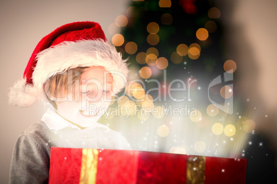 Composite image of child opening his christmas present