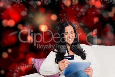 Composite image of woman sitting with tablet pc