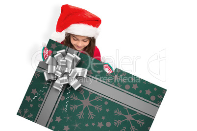 Composite image of festive little girl showing card