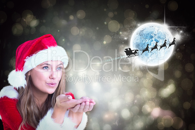 Composite image of festive blonde blowing over hands