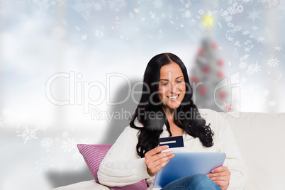 Composite image of woman sitting with tablet pc