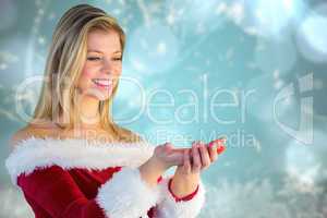 Composite image of pretty girl holding hands out in santa outfit