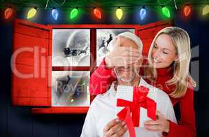 Composite image of loving couple with gift