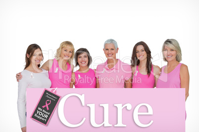 Composite image of smiling women wearing pink for breast cancer