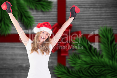 Composite image of festive blonde with boxing gloves