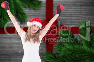 Composite image of festive blonde with boxing gloves