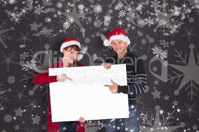 Couple holding a white sign together