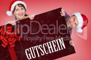Composite image of couple both wearing santa hats