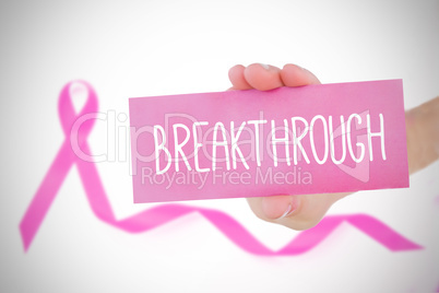 Composite image of young woman holding pink card