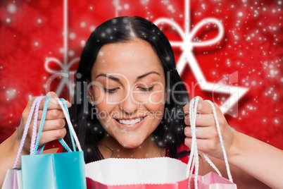 Composite image of woman standing with shopping bags