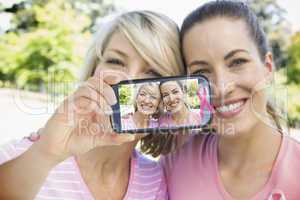 Composite image of hand holding smartphone showing