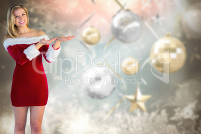 Composite image of pretty girl presenting in santa outfit