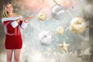 Composite image of pretty girl presenting in santa outfit