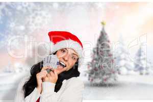 Composite image of woman holding money towards herself