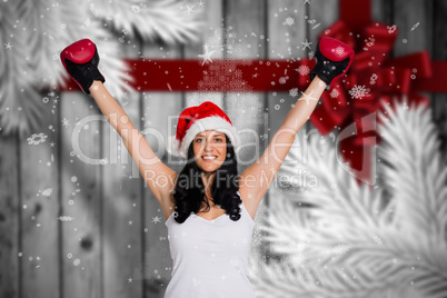 Composite image of woman wearing red boxing gloves