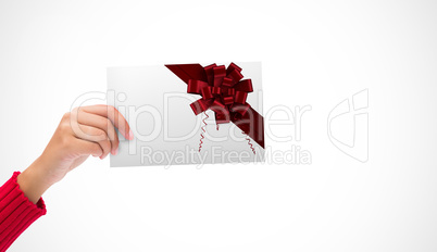 Composite image of hand holding card