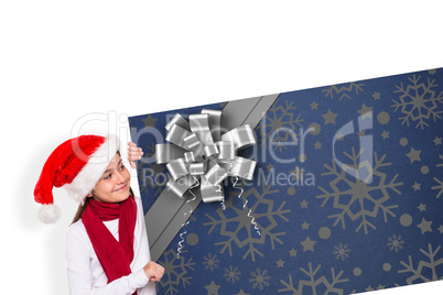 Composite image of festive little girl showing card