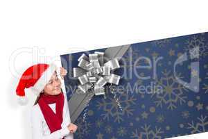 Composite image of festive little girl showing card