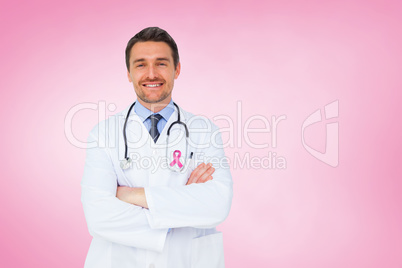 Composite image of handsome young doctor with arms crossed