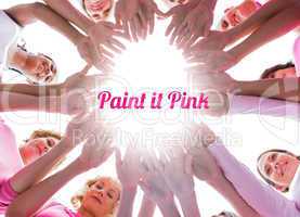 Happy women in circle wearing pink for breast cancer