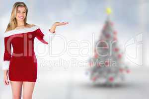 Composite image of pretty girl presenting in santa outfit