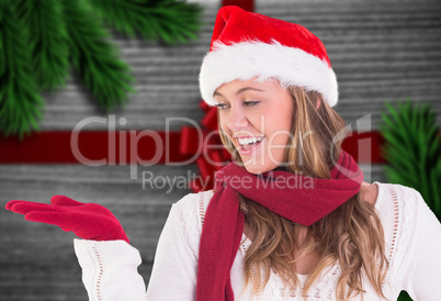 Composite image of festive blonde presenting with hand