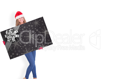 Composite image of festive blonde holding a poster