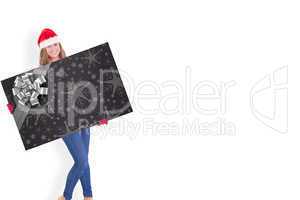 Composite image of festive blonde holding a poster