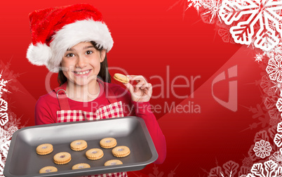 Composite image of festive little girl offering cookies