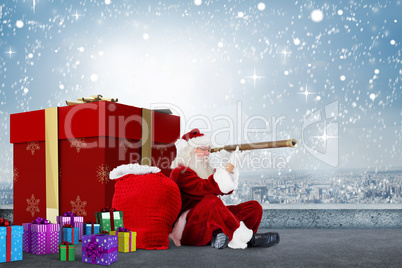 Composite image of santa looking through a telescope