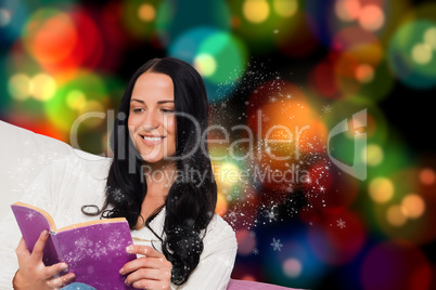 Composite image of smiling woman reading a book