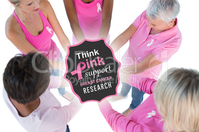 Composite image of group wearing pink and ribbons for breast can