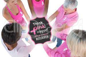 Composite image of group wearing pink and ribbons for breast can