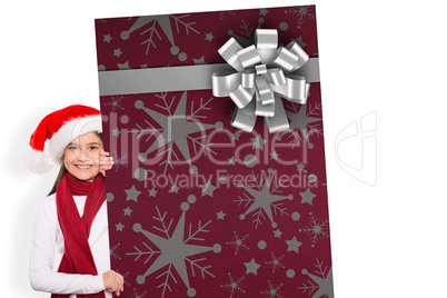 Composite image of festive little girl showing card