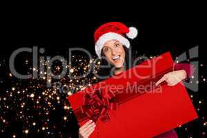 Woman pointing at sign with red christmas ribbon