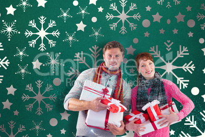 Composite image of couple holding lots of presents