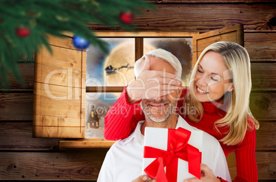 Composite image of loving couple with gift